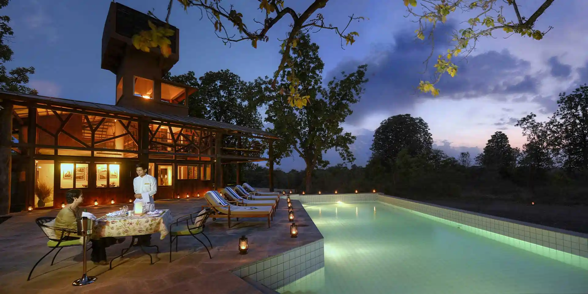 Swimming pool at Pench Tree Lodge at dusk
